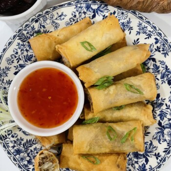 A plate full or crispy fried spring rolls