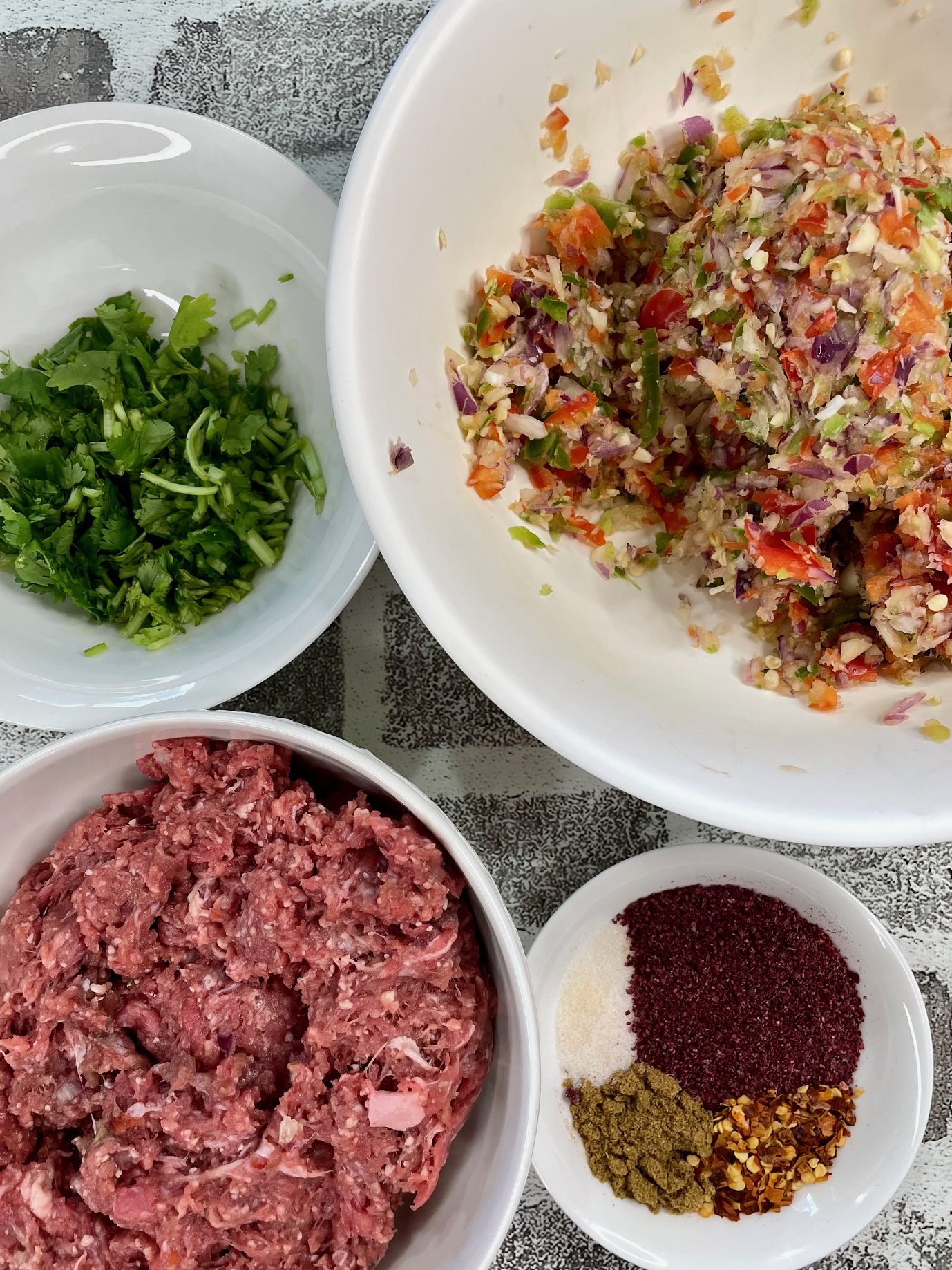 ground lamb, salt, red chili flakes, sumac and cumin powder, fresh herbs to make the kebabs