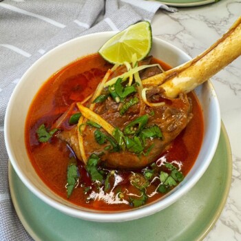 Lamb shanks are cooked with spices until soft and fall off the bones