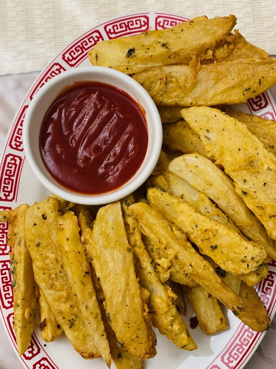 Potatoes wedges coated in the batter and then fried until crispy