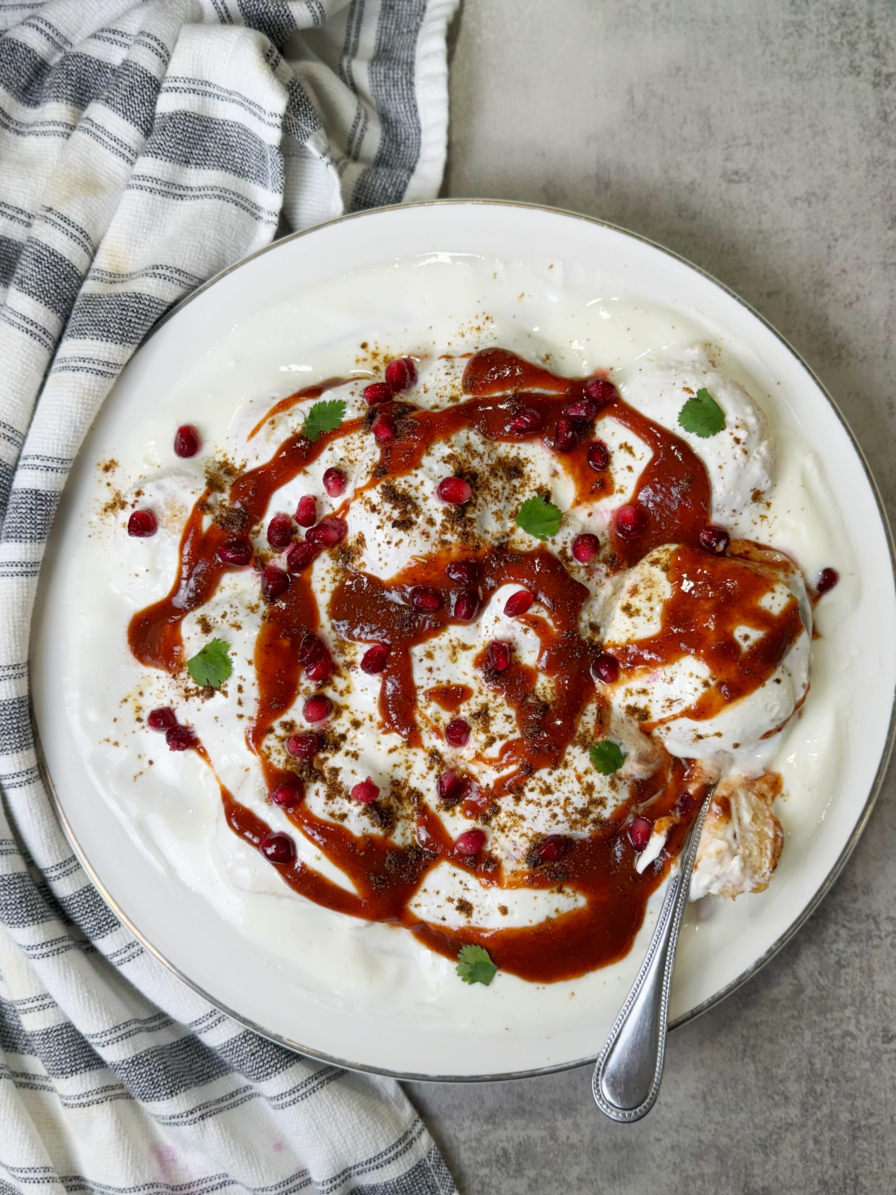 Meethy dahi bhary are made with mash ki daal and served with sweet yogurt and sauces