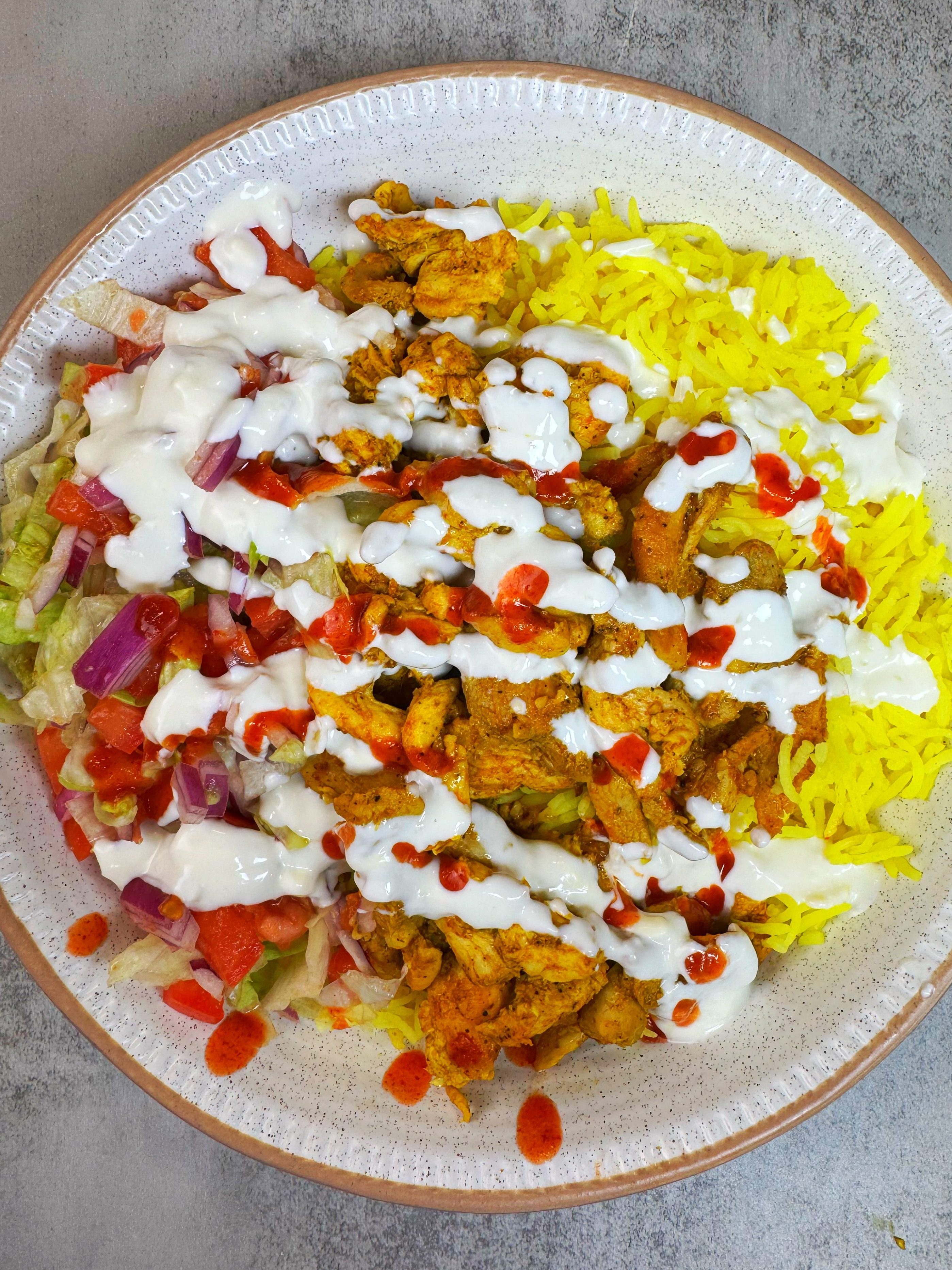 marinated chicken is cooked and then served with rice, salad and white sauce which is an amazing combination and will come back to it over and over again