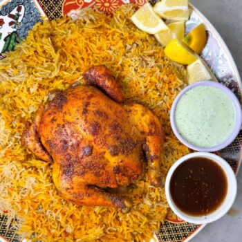 Whole chicken is marinated and baked with sajji masala, then served with fragrant sajji rice