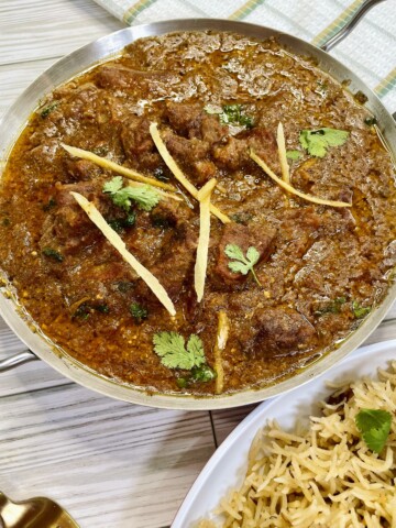Beef cubes are fried with spices and then cooked with tomatoes until fork tender.