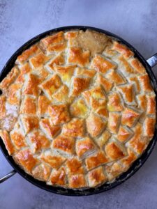 A freshly packed chicken and mushroom pie freshly out of the oven