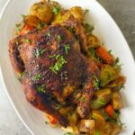 A whole baked chicken with vegetables