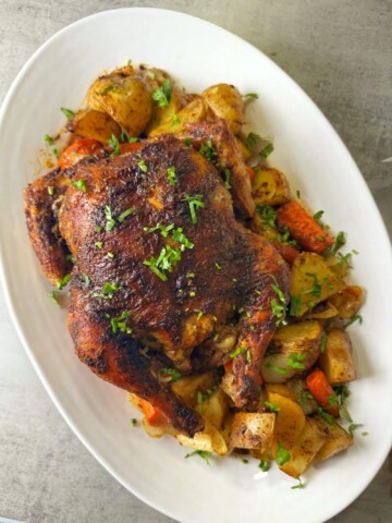 A whole baked chicken with vegetables