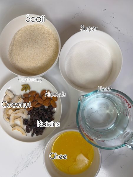 A photo that shows sooji, sugar, water, nut and ghee to make sooji ka halwa