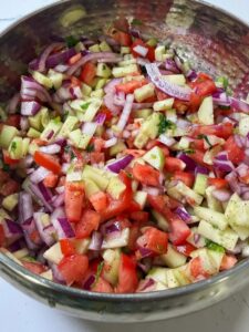 A bowl full of kachumer salad