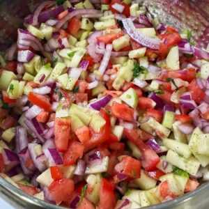 A bowl full of kachumer salad
