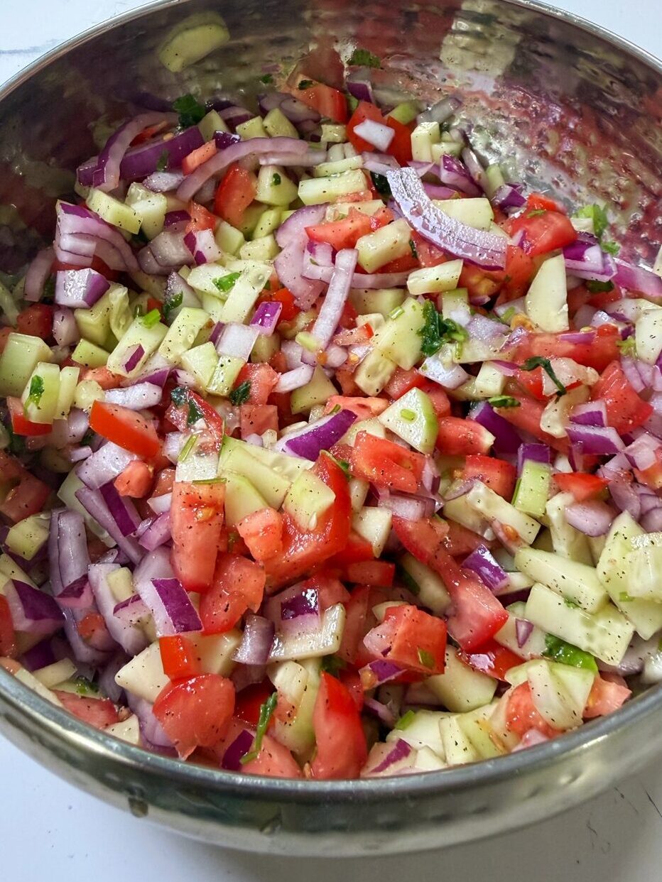 A bowl full of kachumer salad